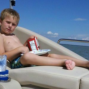 son eating lunch in his favorite starboard lounger