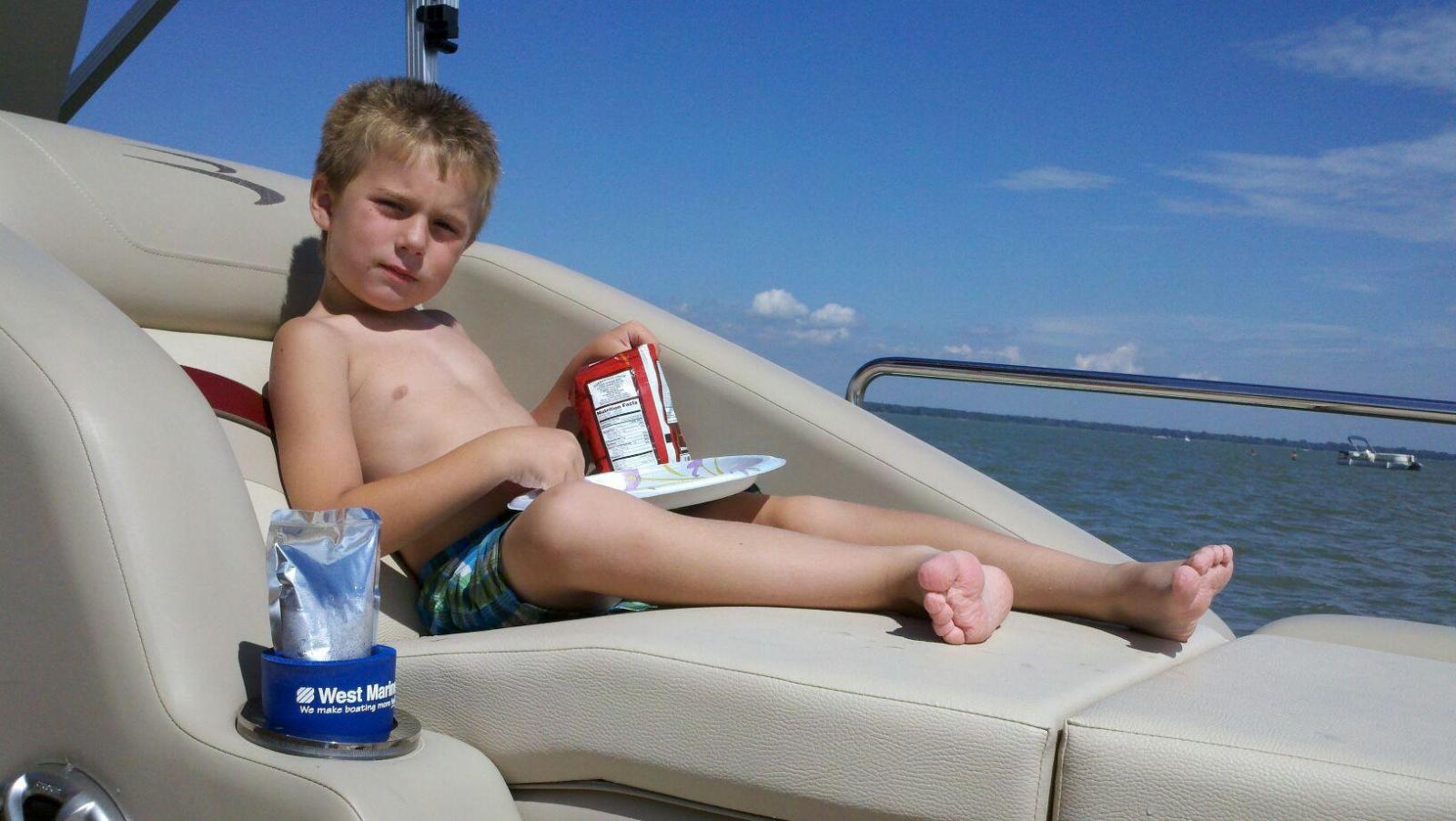 son eating lunch in his favorite starboard lounger
